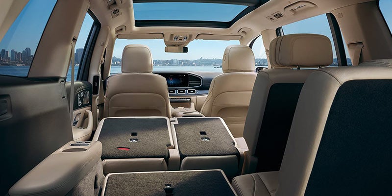 Spacious SUV interior with rear seats folded flat, showing expanded cargo area and panoramic sunroof