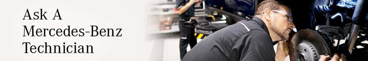 Ask A Mercedes-Benz Technician next to a man in safety glasses inspecting a car's brake rotor.