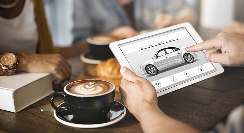 Customer browsing vehicle details on tablet
