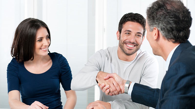Service advisor shaking hands with a customer