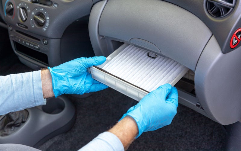Service technician working under the hood of a vehicle