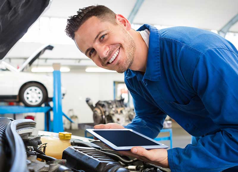 Service advisor inspecting vehicle