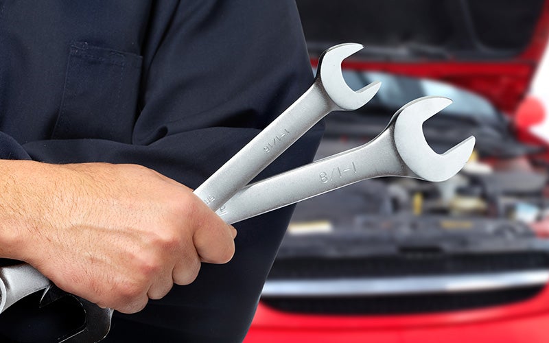Automotive repair tools in technician's hands